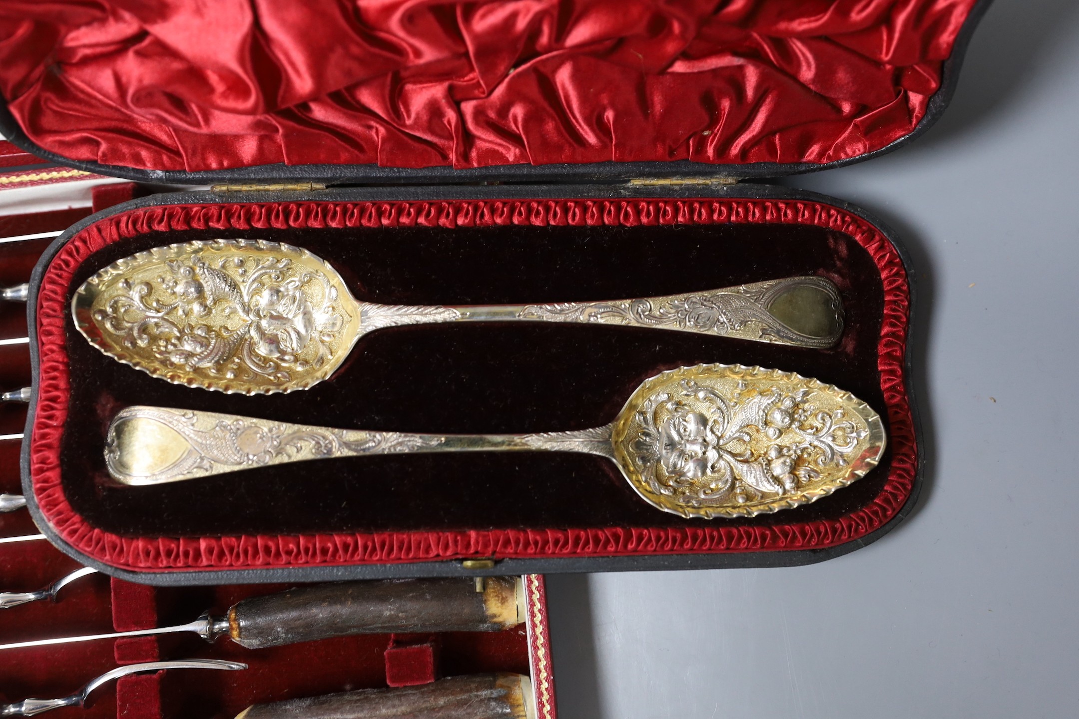 Four cased sets of flatware, including silver 'berry spoons', tea knives, teaspoons and horn handles knives and forks.